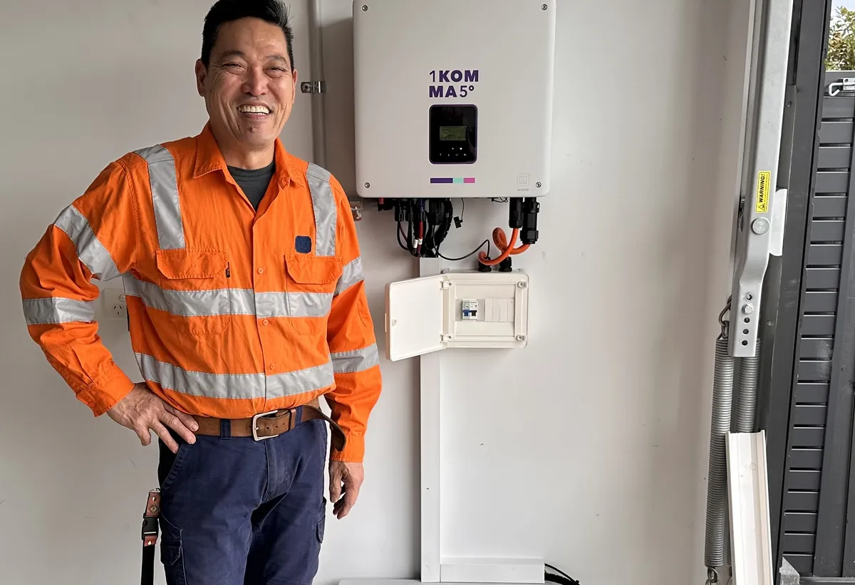 Image of Peco&Co founder Ruben next to a solar inverter, on the About page for a registered electrical contractor in Melbourne