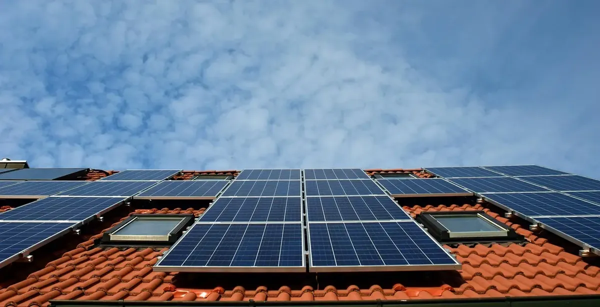 hero img of solar panels on a roof in daylight for the solar services sub page outlining solar and battery services offered by Peco&Co.